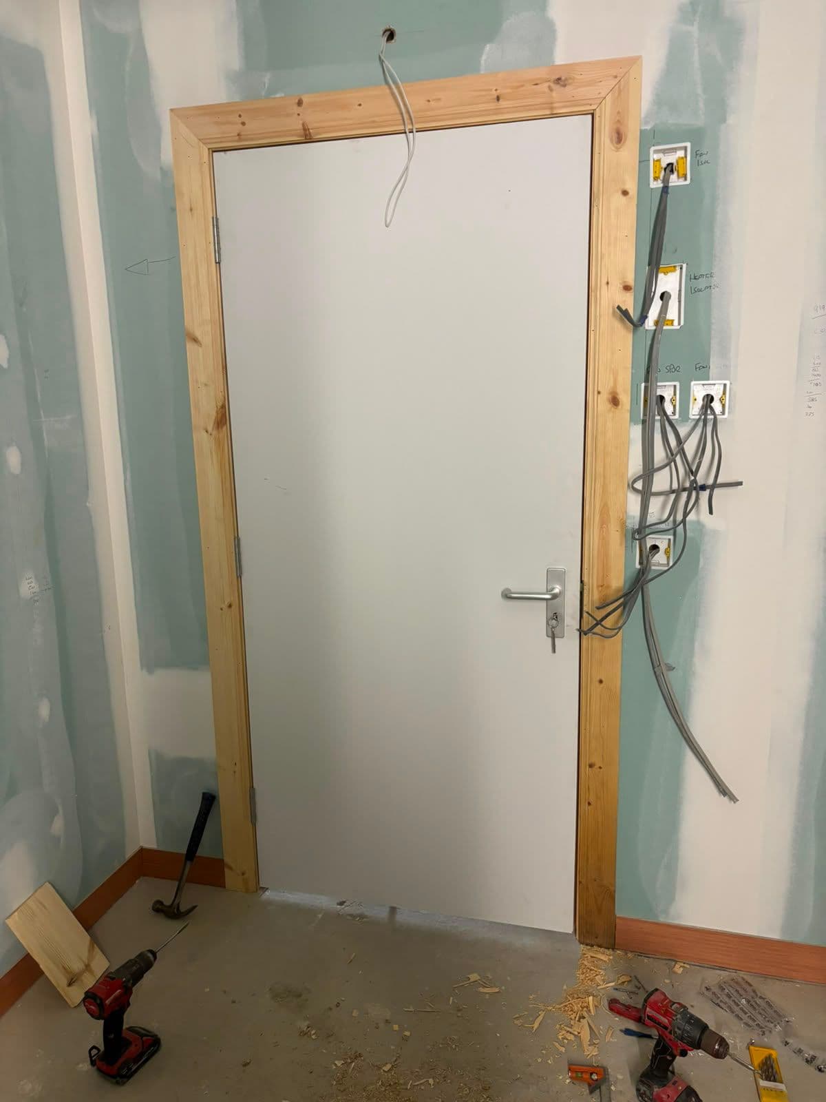 New timber door frame and first-fix electrics in a renovated room